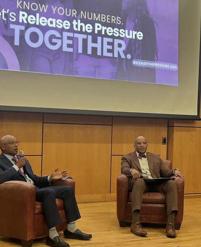 Study leaders speak at a public event on stage